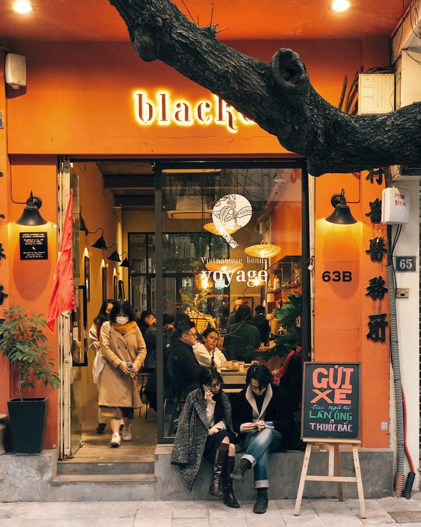 Blackbird Coffee Hà Nội 9 Mặt tiền quán cà phê phố cổ màu cam, khách ngồi và đi lại trước cửa