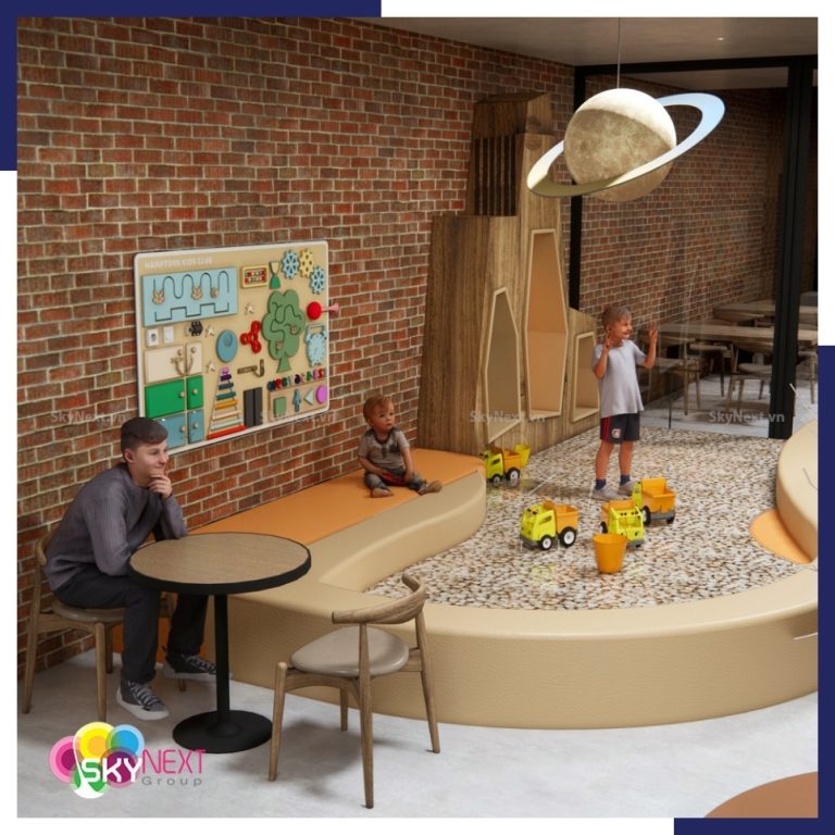 Khu vui chơi tầng hầm với hố cát, xe đồ chơi, bảng hoạt động và ghế ngồi